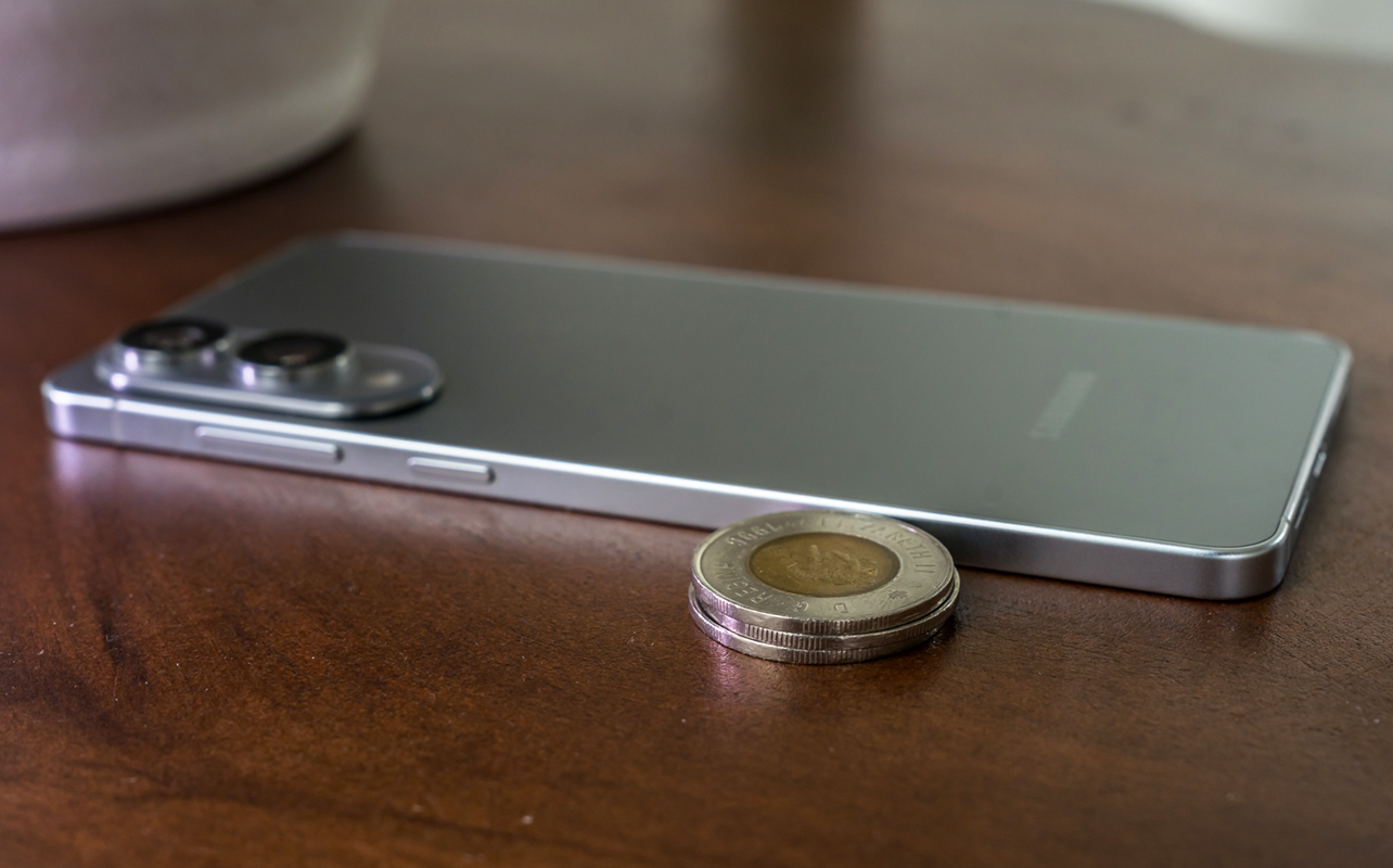 Samsung Galaxy S25 Edge next to stacked Canadian toonie coins.