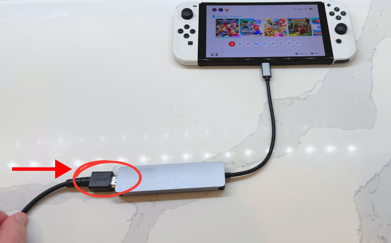 The Nintendo Switch console's third-party hub is connected to an HDMI cable.