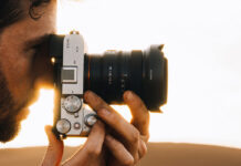 Man taking photo on Sony camera with wide-angle lens.