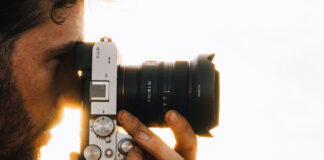 Man taking photo on Sony camera with wide-angle lens.