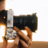 Man taking photo on Sony camera with wide-angle lens.
