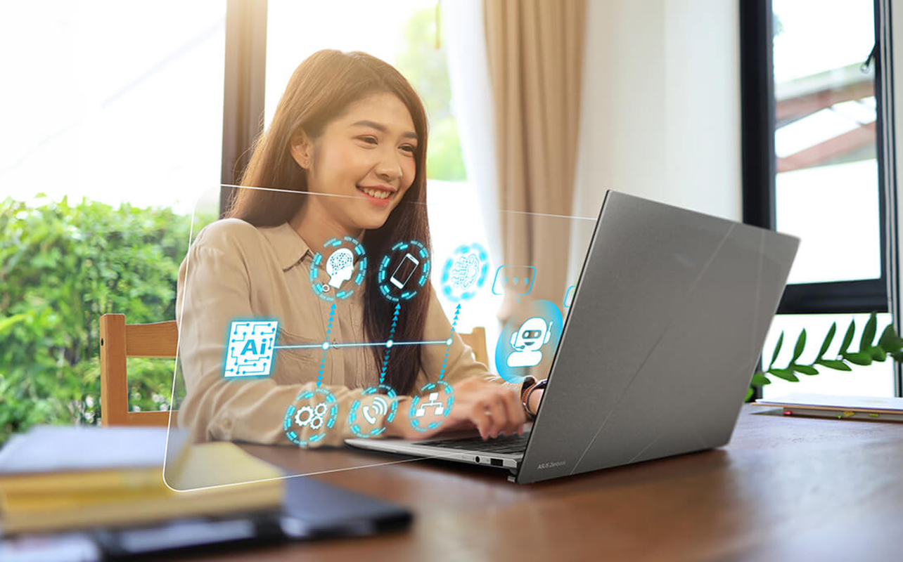 Woman using AI laptop with graphics showing what's possible.