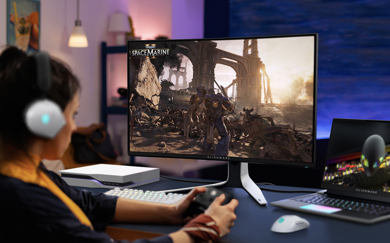 A woman gaming with an Alienware monitor.