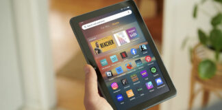 A hand holding an Amazon Fire tablet