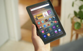 A hand holding an Amazon Fire tablet