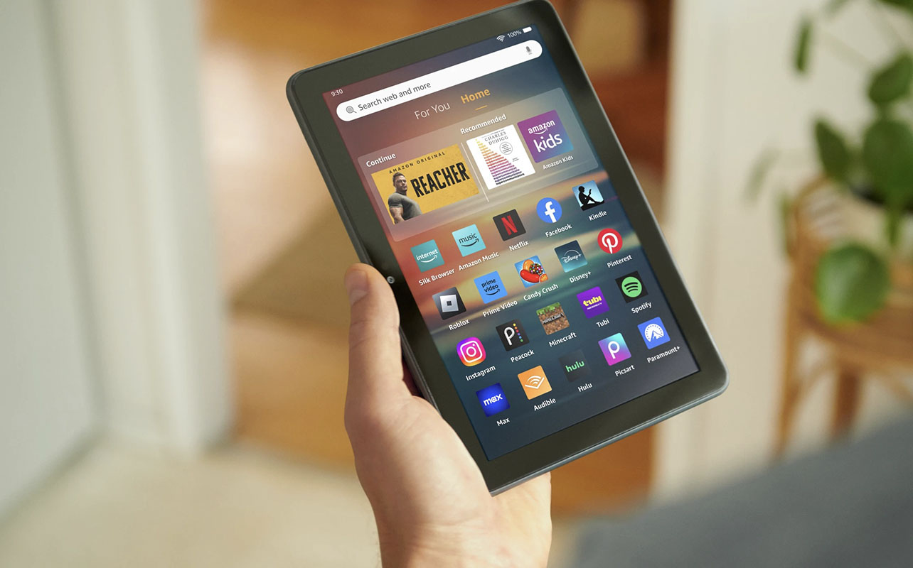A hand holding an Amazon Fire tablet