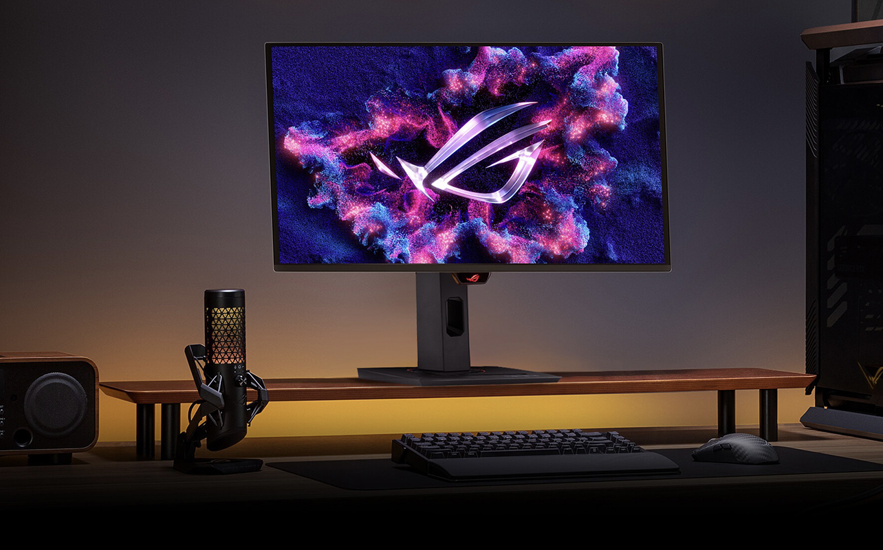 An ASUS Rog gaming monitor on a desk in a dark room.
