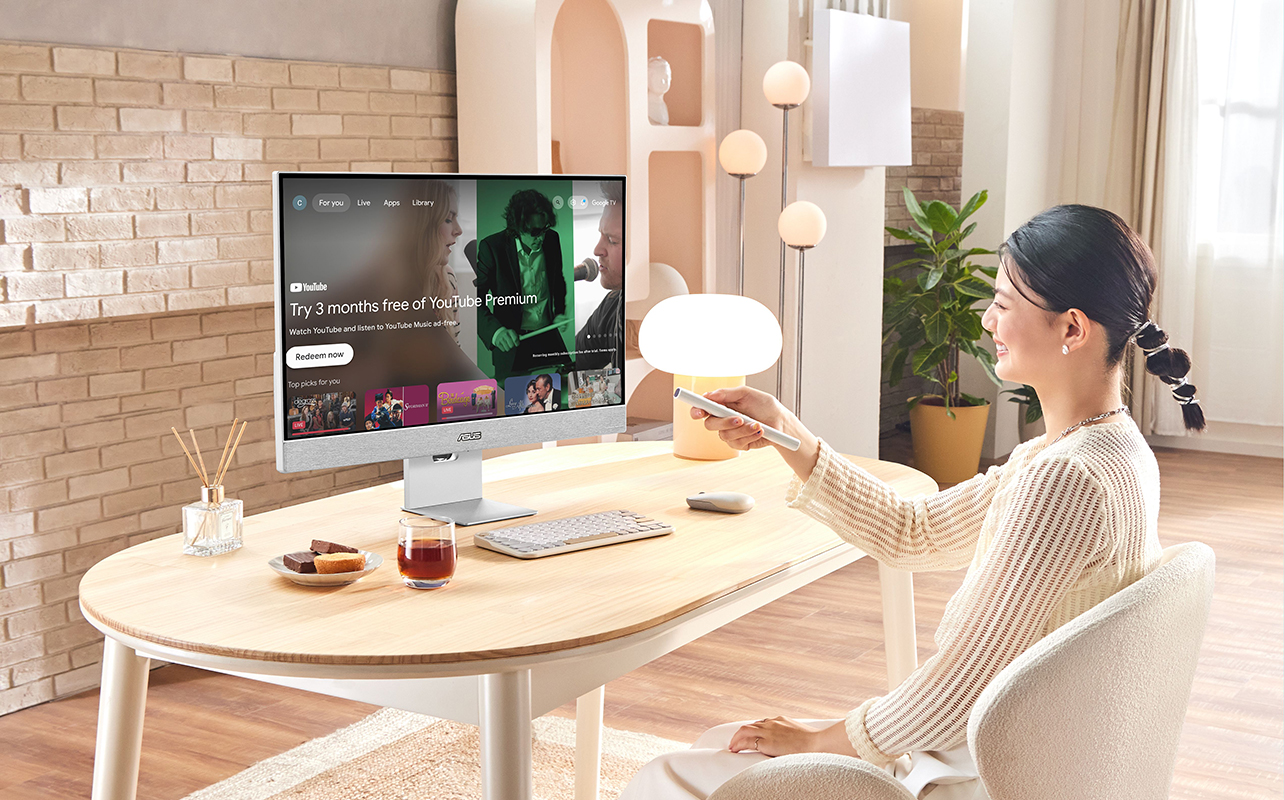 A woman sitting back in her chair with the ASUS Zenscreen smart monitor on the desk.