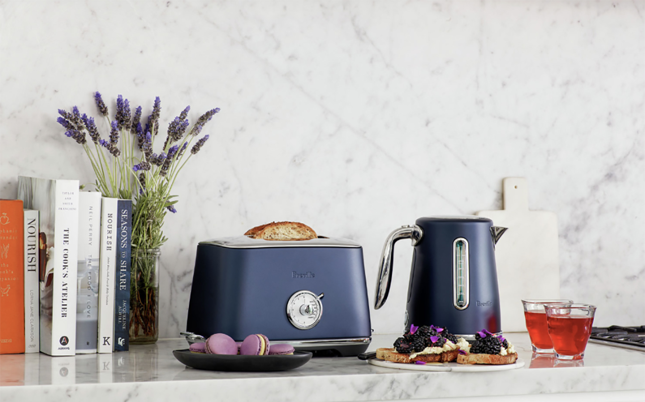A Breville smart toaster and kettle in blue on a kitchen counter.