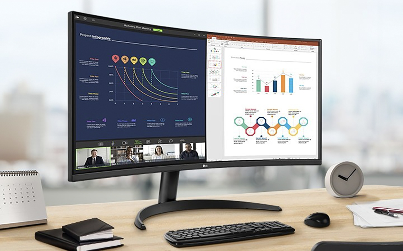 An LG UltraWide curved nonitor on a desk showing graphs.