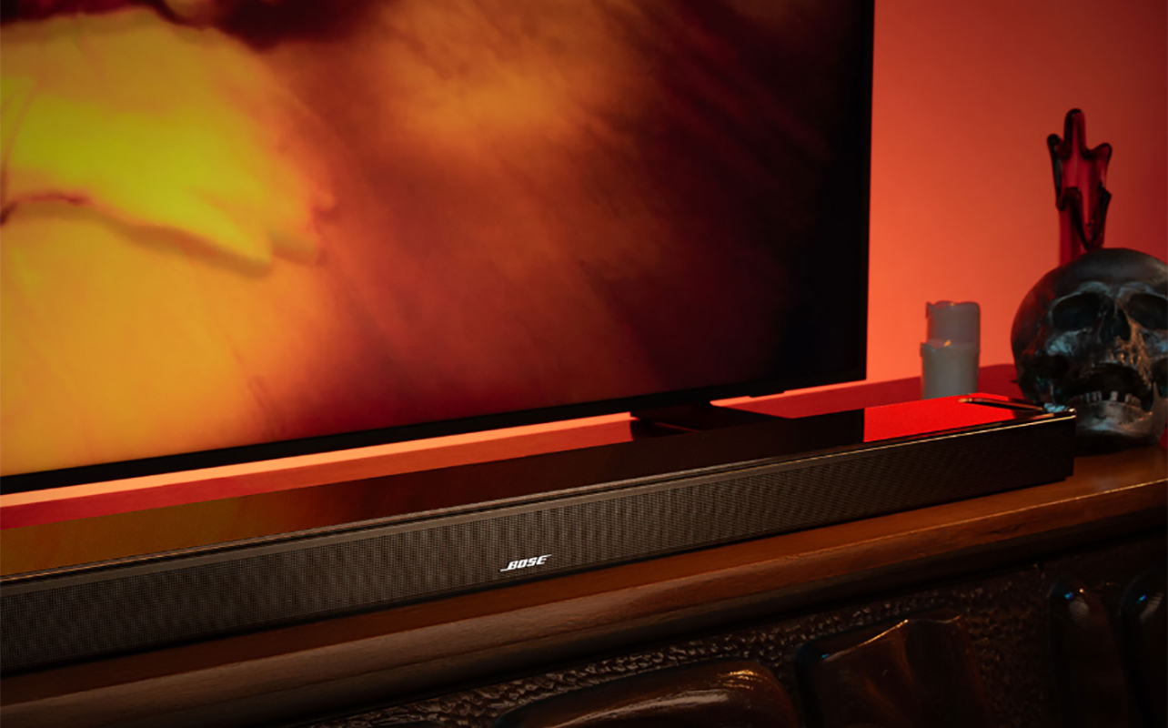 A side view of a TV with a Bose Smart Ultra 5-channel sound bar under it.