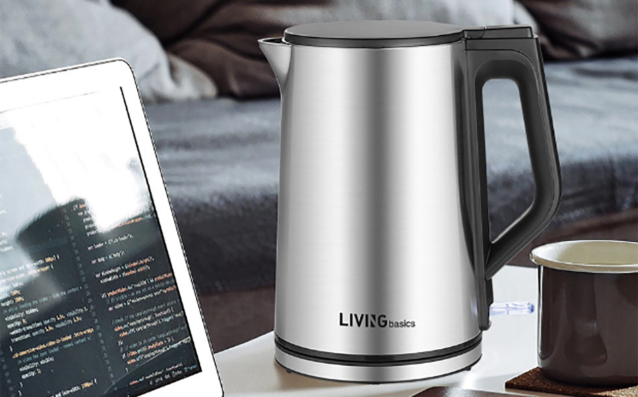 A BPA free kettle beside a computer and coffee mug
