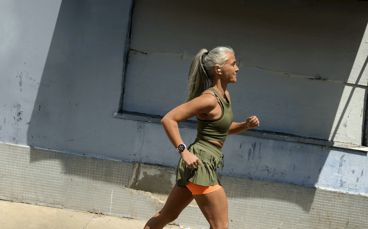 A woman running while wearing a Google Pixel Watch 3.