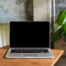Laptop computer blank screen on table in cafe background. Laptop with blank screen on table of coffee shop blur background