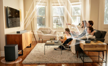 A family watching TV with the JBL Bar 820 9-channel sound bar mounted and lines showing the different channels and how and where they send audio.