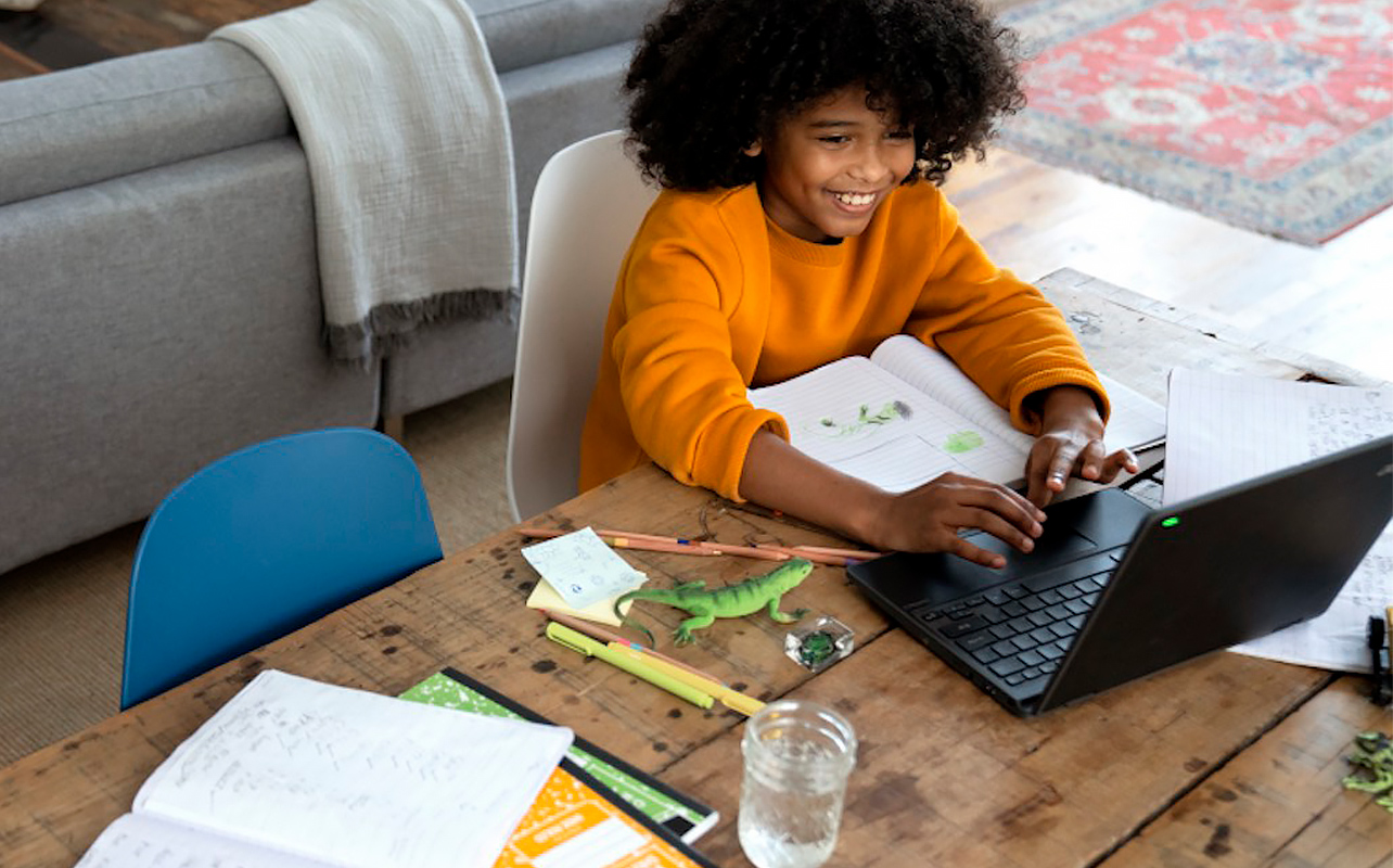 A young student uses their laptop for school work.