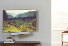 A TV mounted with a Sonos Beam soundbar underneath, mounted on a Sanus mount.