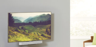 A TV mounted with a Sonos Beam soundbar underneath, mounted on a Sanus mount.