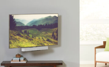 A TV mounted with a Sonos Beam soundbar underneath, mounted on a Sanus mount.