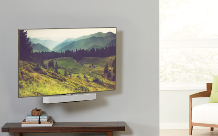 A TV mounted with a Sonos Beam soundbar underneath, mounted on a Sanus mount.
