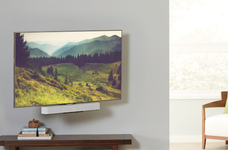 A TV mounted with a Sonos Beam soundbar underneath, mounted on a Sanus mount.