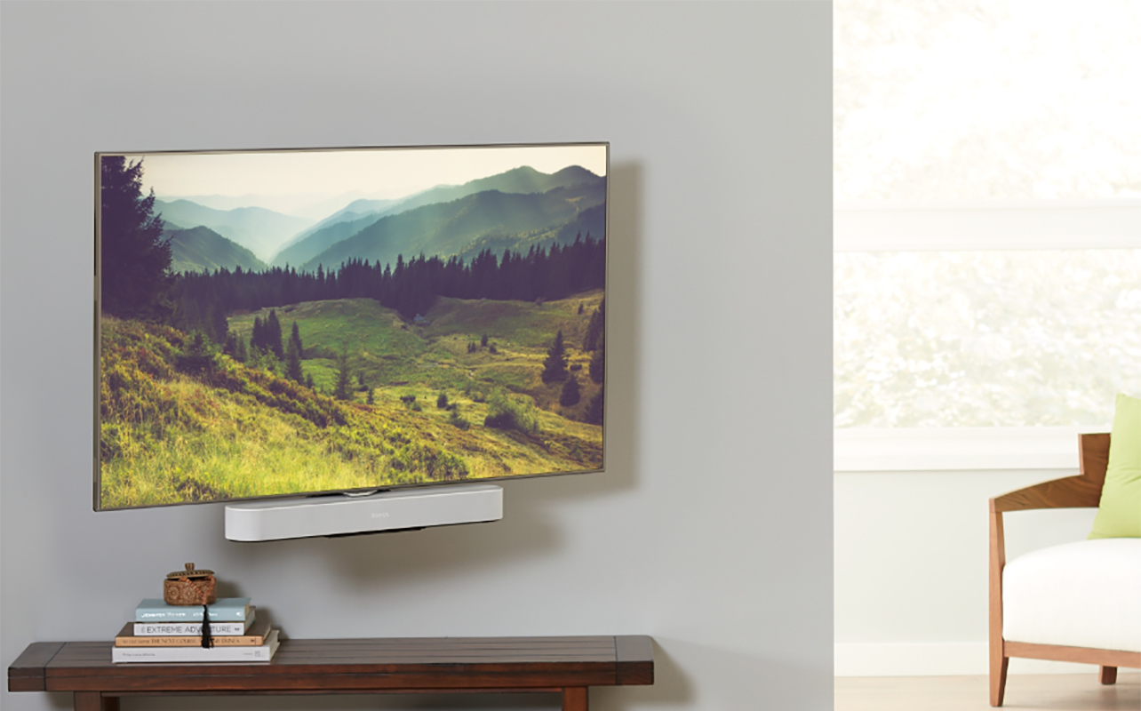 A TV mounted with a Sonos Beam soundbar underneath, mounted on a Sanus mount.
