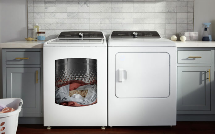 A Whirlpool washer and dryer with clothing in the washer.