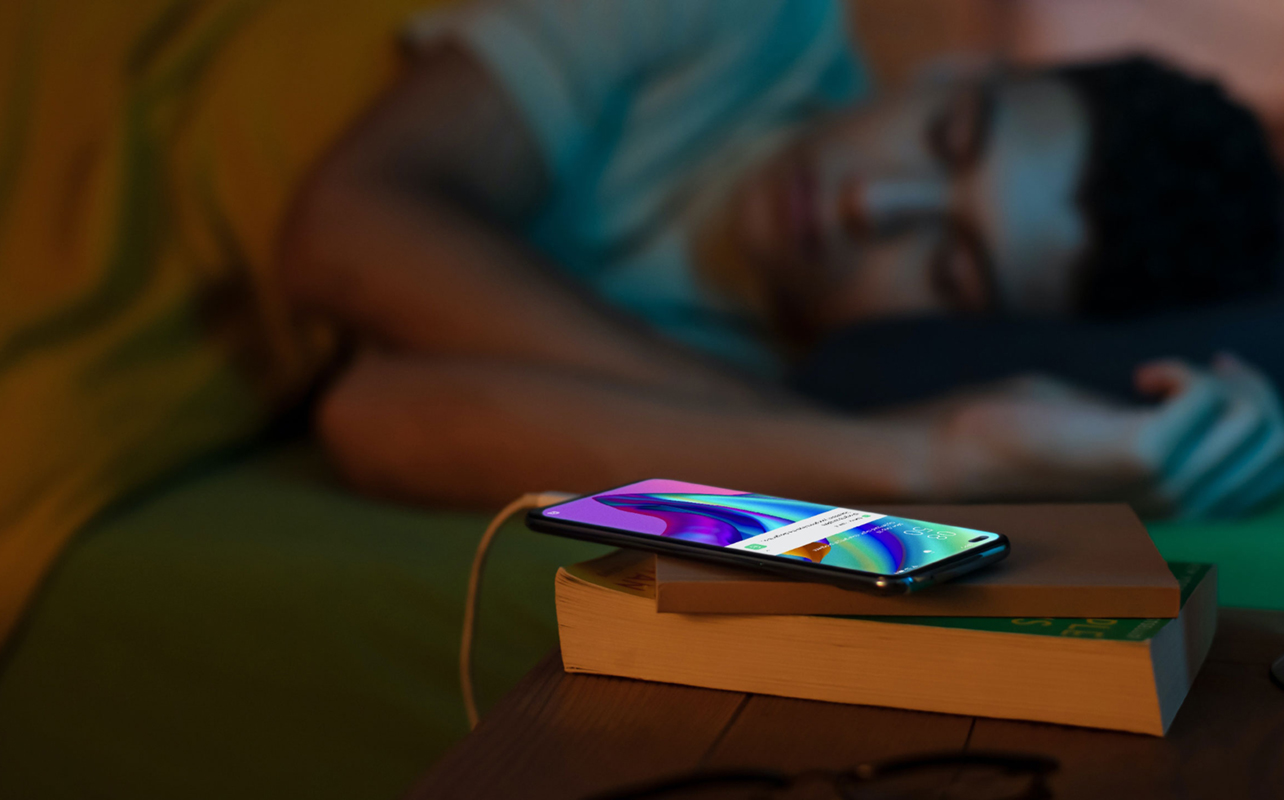 Man asleep while charging phone overnight.