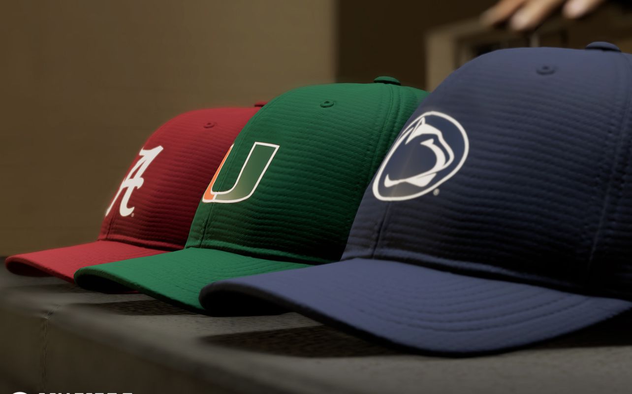 Three caps are on display: a red cap with a white logo, a green cap with a multi-coloured logo, and a navy cap with a white logo. Neutral background.