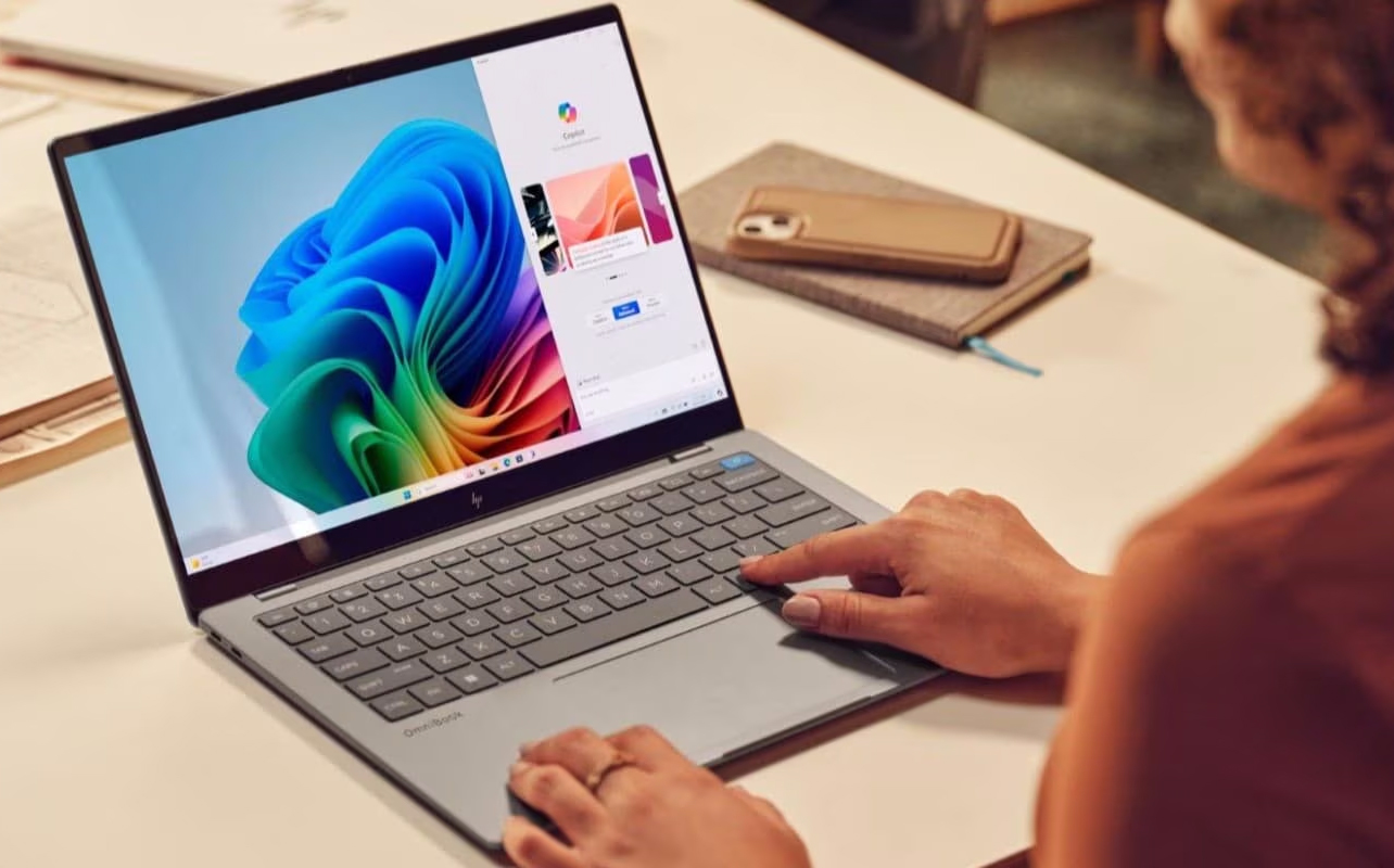 Woman using Copilot+on an HP laptop.