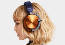 Blonde woman wearing Dyson OnTrac headphones in nickel and purple.
