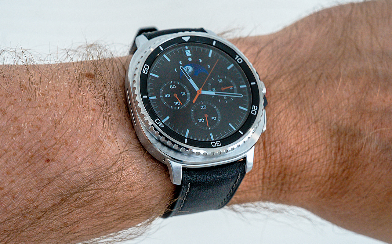 Samsung Galaxy Watch8 Classic on wrist with analog watch face.