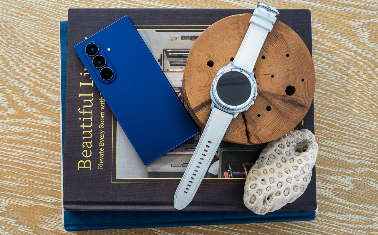 Samsung Galaxy Z Fold7 next to Galaxy Watch8 Classic on top of books.
