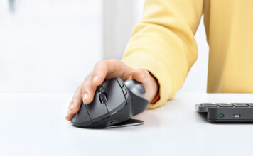 Person using Logitech MX Ergo mouse and trackball on desk.
