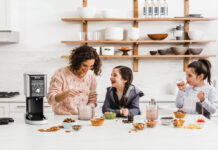 mother and two daughters having fun, making ice cream together with a Ninja ice cream maker.