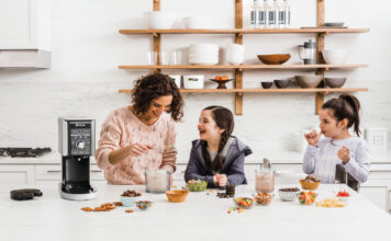 mother and two daughters having fun, making ice cream together with a Ninja ice cream maker.
