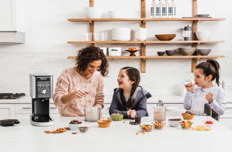mother and two daughters having fun, making ice cream together with a Ninja ice cream maker.