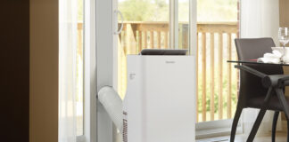 A Danby portable air conditioner by a large window.