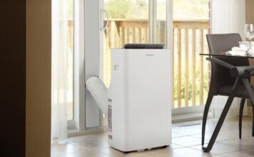 A Danby portable air conditioner by a large window.