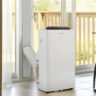 A Danby portable air conditioner by a large window.
