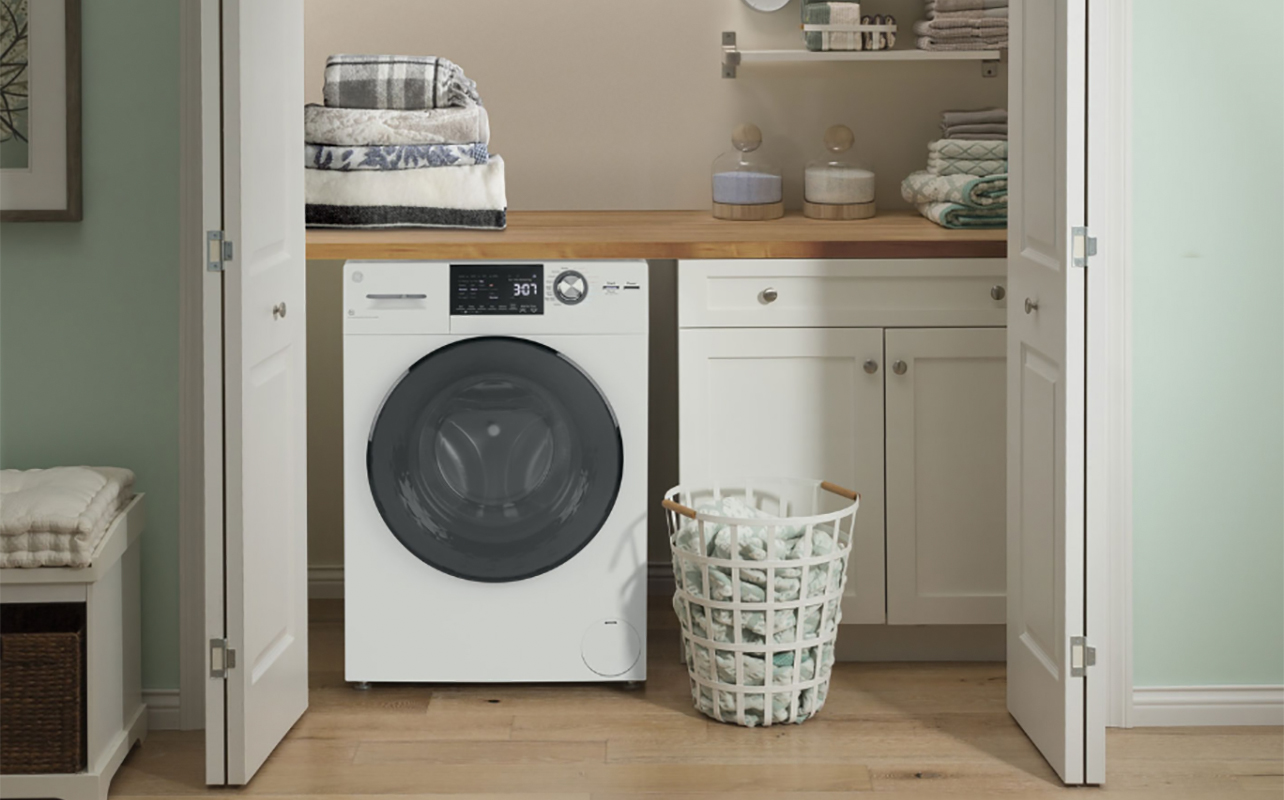 A GE washer dryer combo in a laundry area.