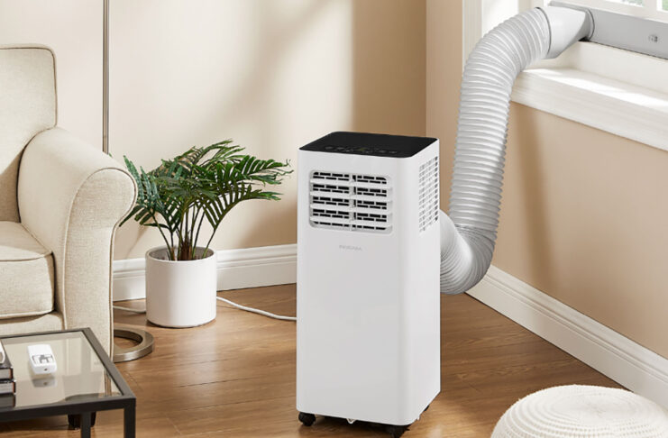 An Insignia portable air conditioner by the window in a living room.
