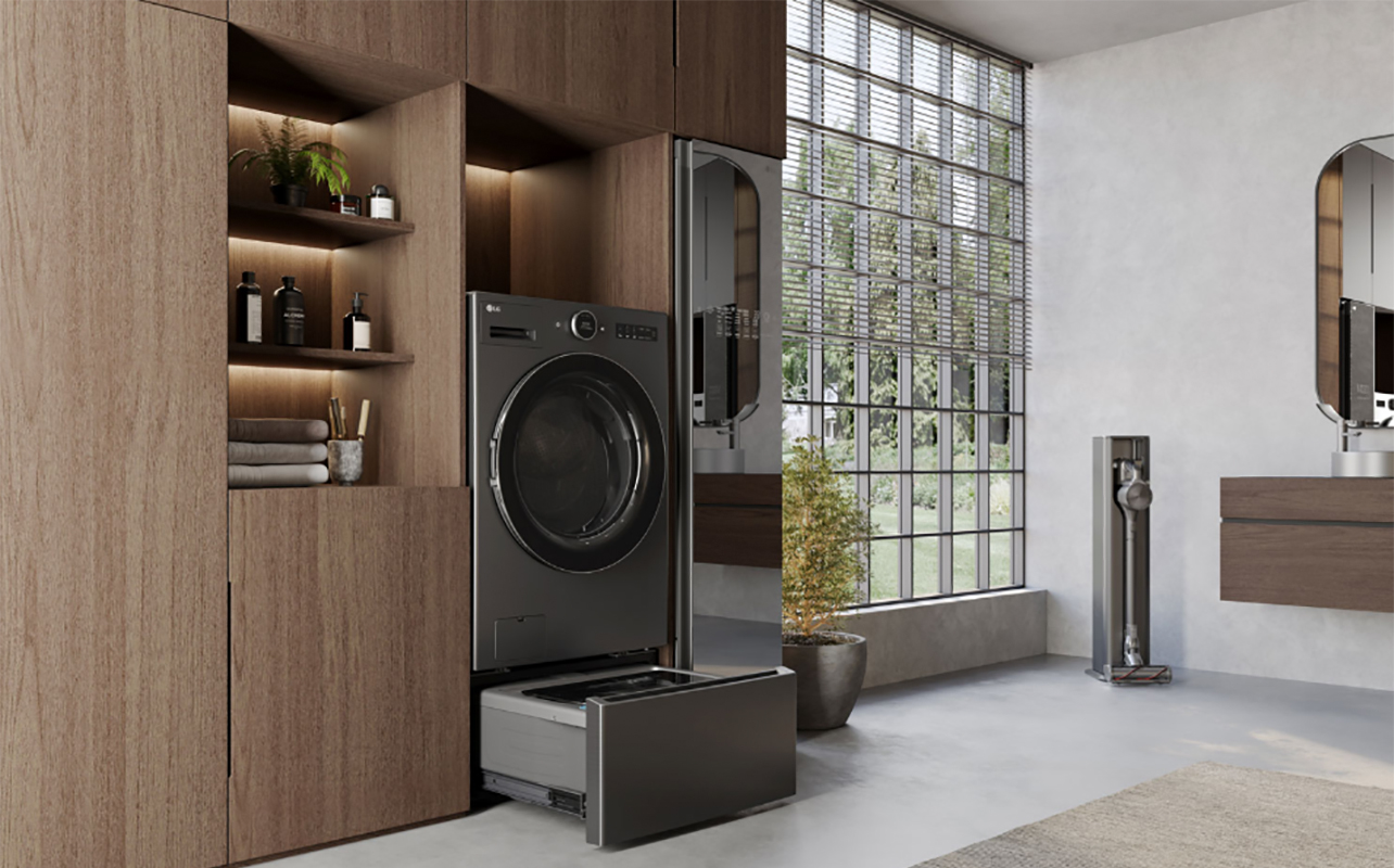 An LG washer dryer combo mounted flush into furniture, the bottom drawer open.
