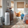 A cylindrical portable air conditioner in a bedroom.