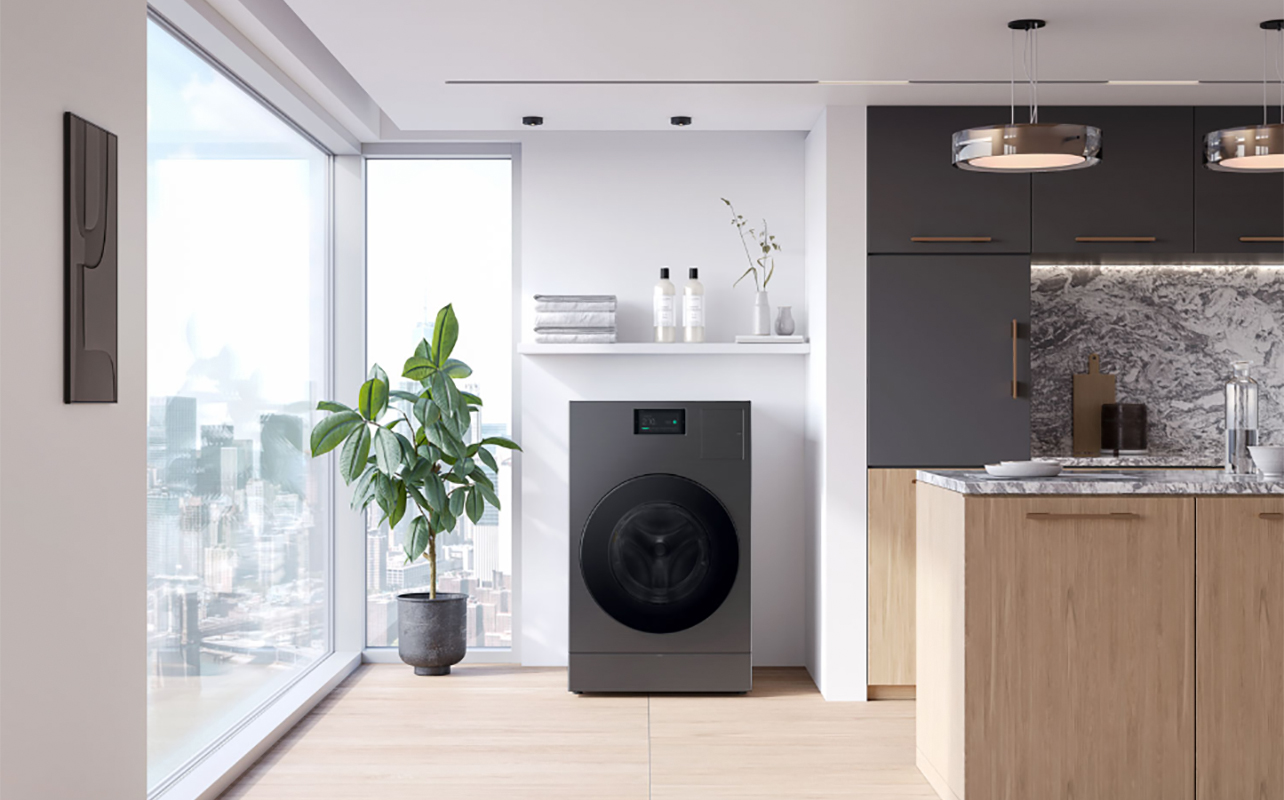 A Samsung washer dryer combo in a bright kitchen by the window.