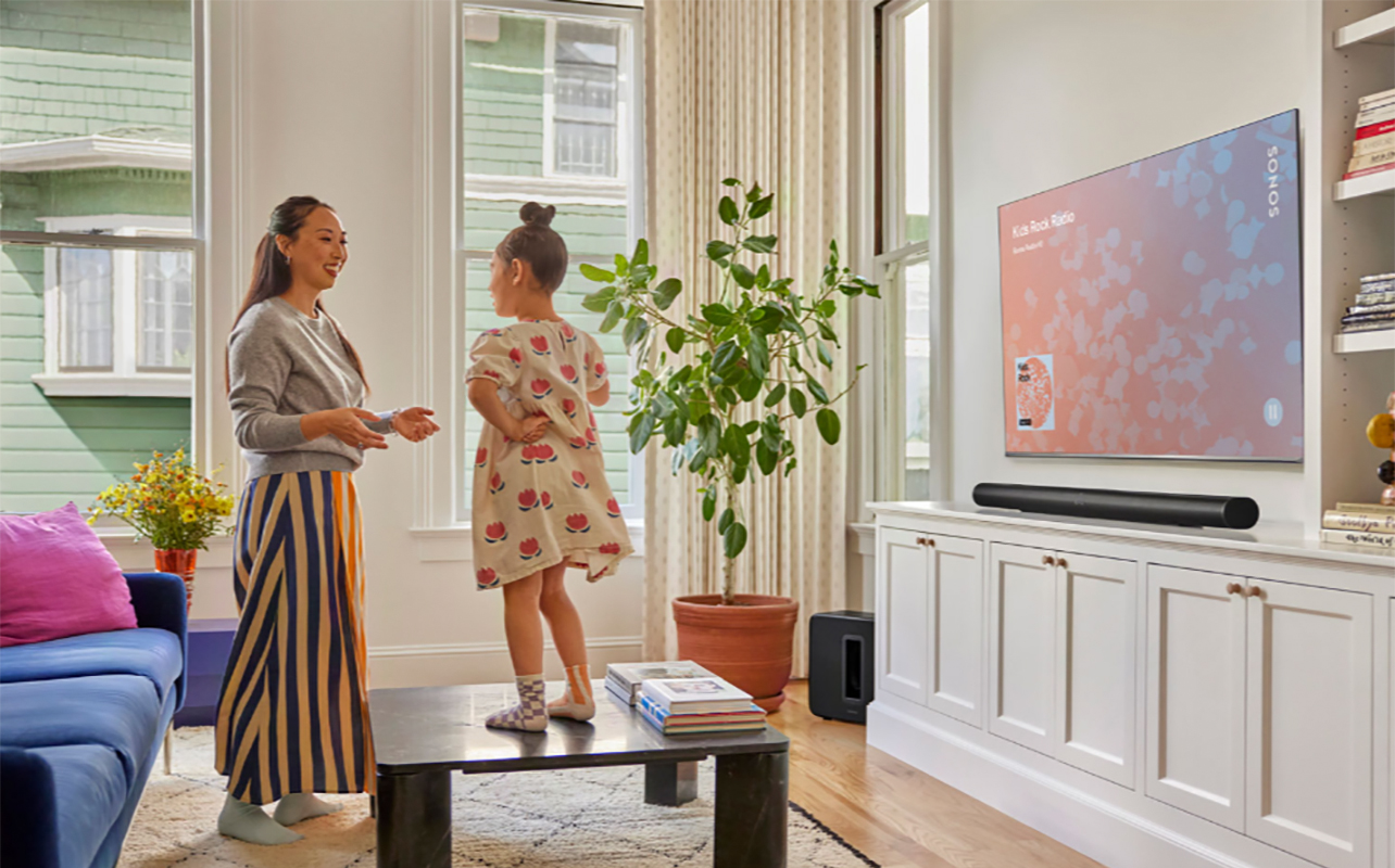 A mother and daughter in the living room with a TV and Sonos Arc Ultra sound bar under it.