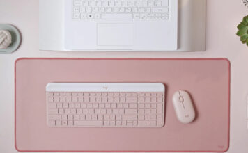Logitech MK470 Slim Combo in pink on similar background in front of laptop.