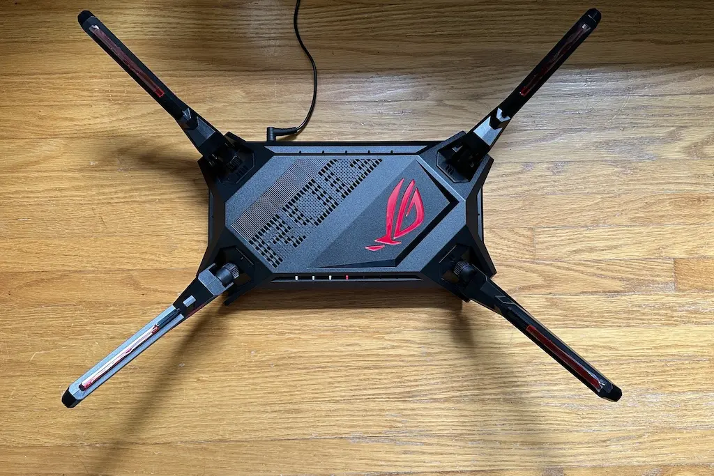 A wi-fi router on a wood floor.