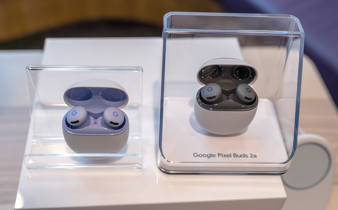 Google Pixel Buds 2a in two colours sitting upright in case.