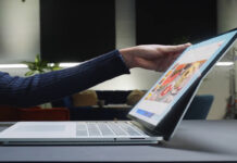 Woman opening Microsoft Surface premium Windows laptop.